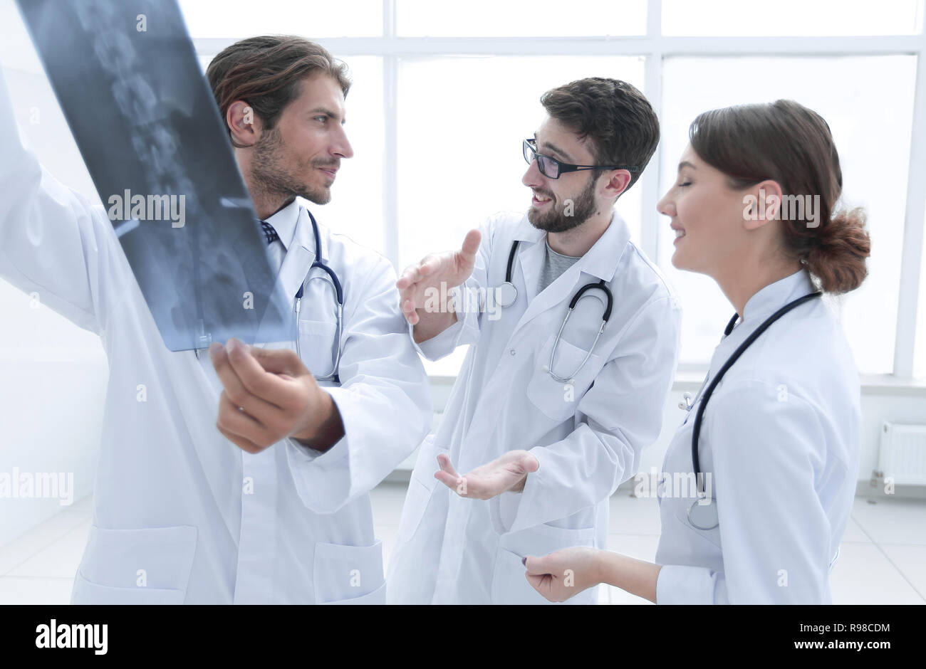 Three Confident Doctors Examine An X Ray Stock Photo Alamy