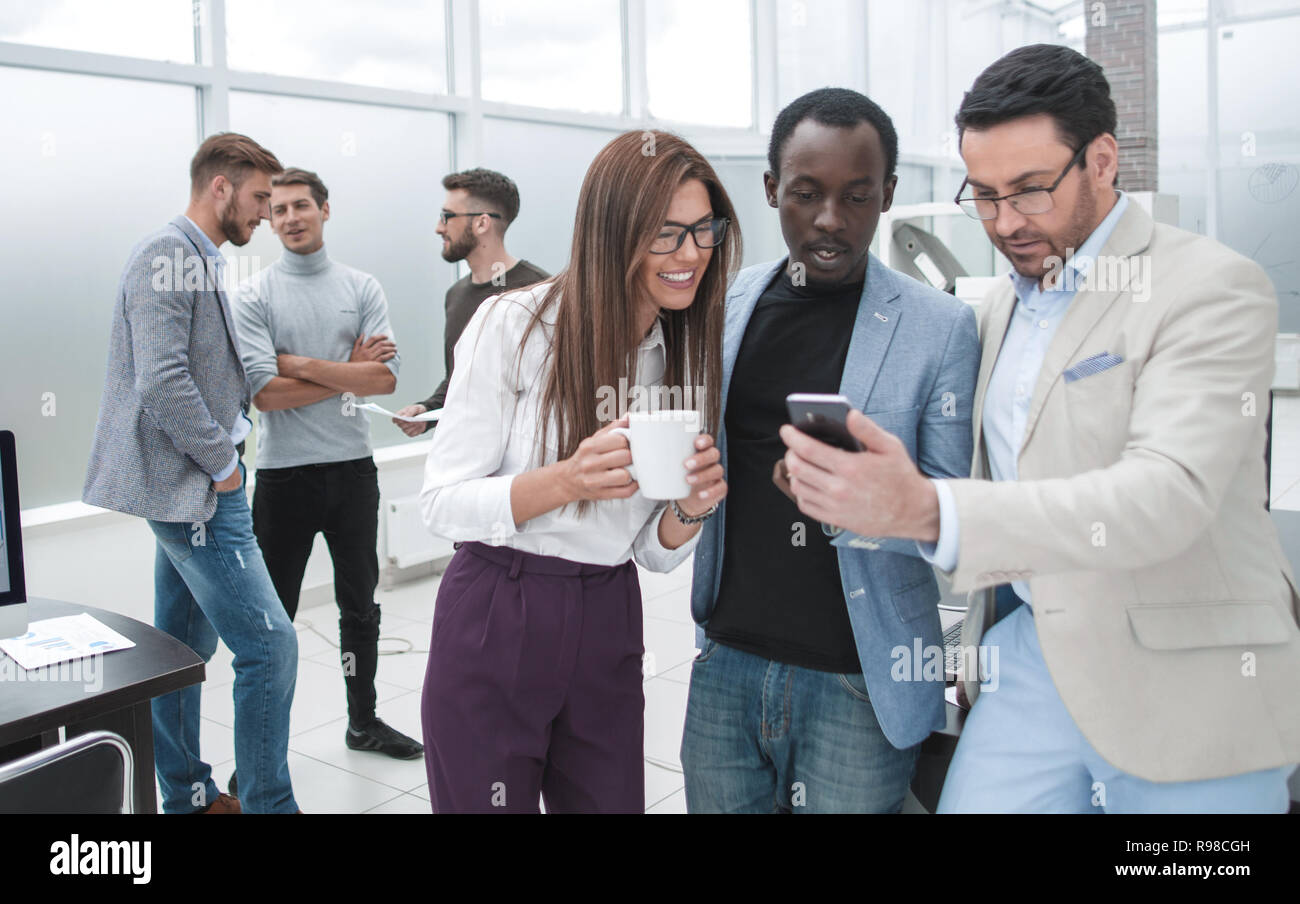 business team talking while standing in a modern office Stock Photo - Alamy