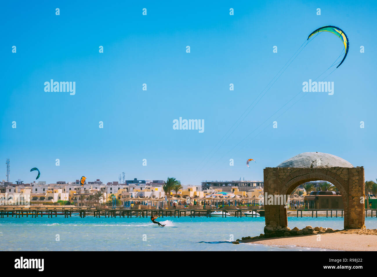 Egypt, Hurghada - 30 November, 2017: The kitesurfer gliding over the Red sea. The stunning beach with the arbor. The tourist attraction next to the Pa Stock Photo