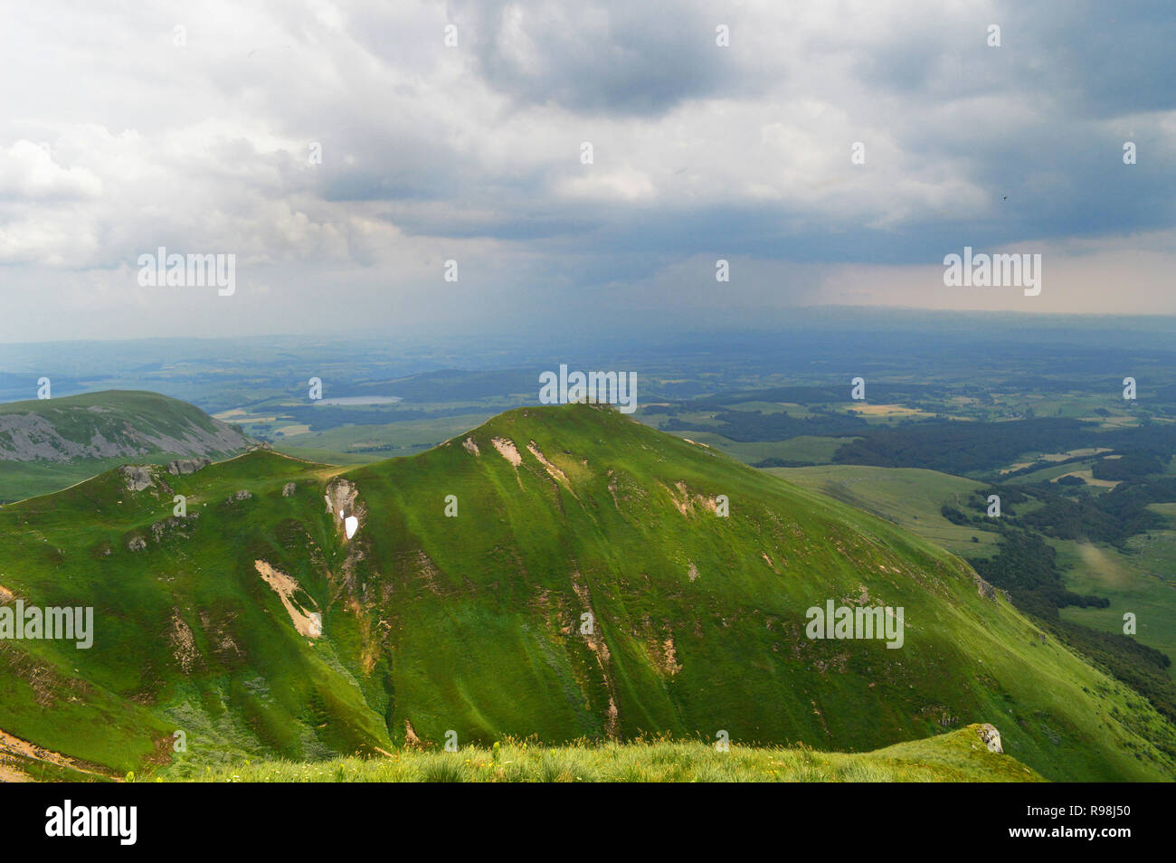 A magnificent panorama and viewpoint from the mountain range of Sancy with a thunderstorm, in Auvergne, France. National Park of the Auvergne volcano Stock Photo