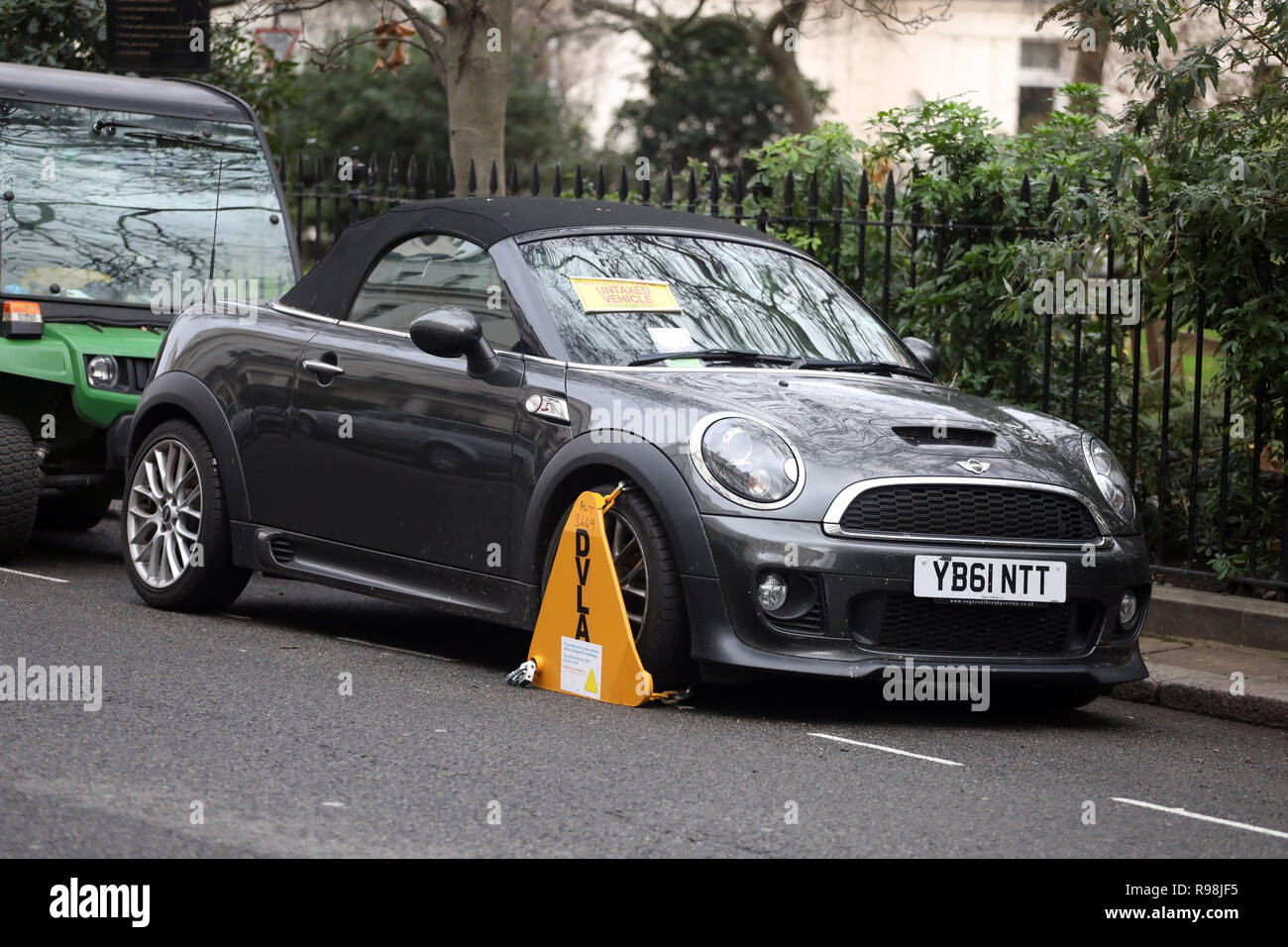Mini Roadster car clamped for have no tax     picture by Gavin Rodgers/ Pixel8000 Stock Photo