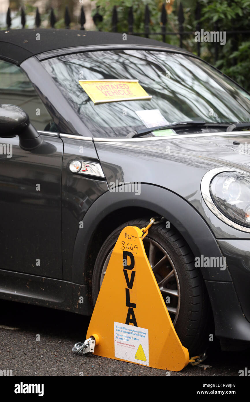 Mini Roadster car clamped for have no tax     picture by Gavin Rodgers/ Pixel8000 Stock Photo