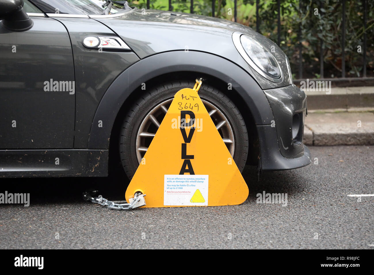 Mini Roadster car clamped for have no tax     picture by Gavin Rodgers/ Pixel8000 Stock Photo