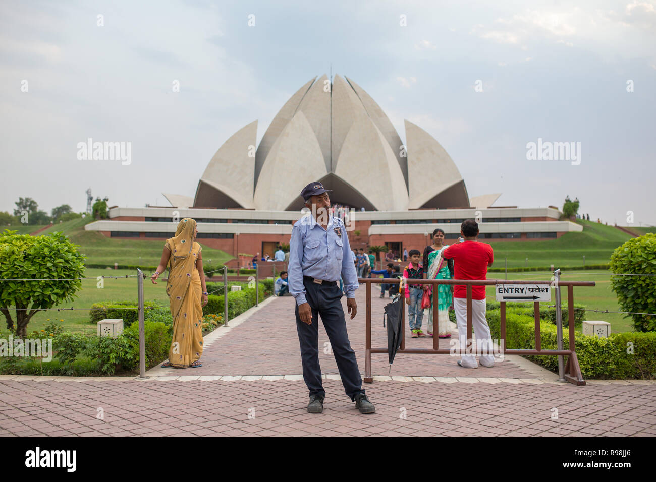 Delhi, India - May 23, 2017: Indian man guards entrance to the famous Lotus Temple or Bahai House of Worship   in New Delhi, India. Stock Photo