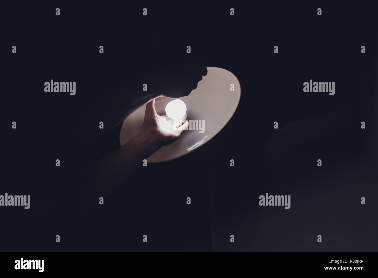 Hands changing with new LED lamp light bulb,Power saving concept. Stock Photo