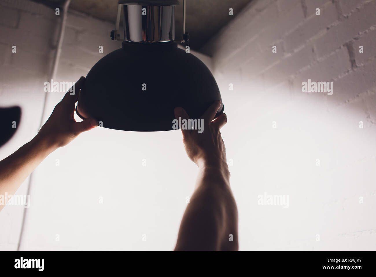 Hands changing with new LED lamp light bulb,Power saving concept. Stock Photo