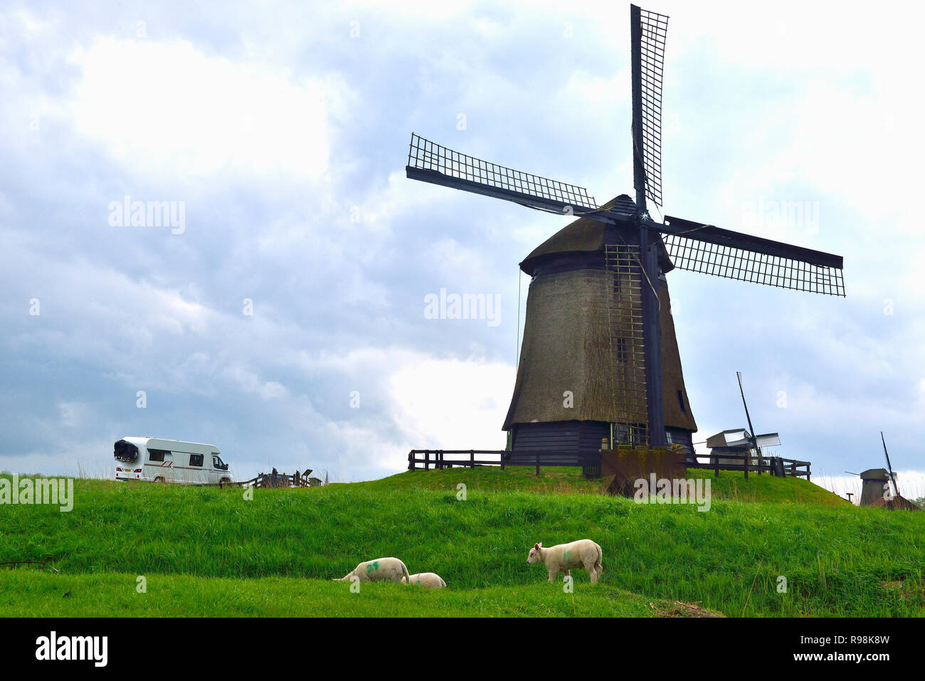 Tourists in a motorhome with the windmills at the Schermerhorn Windmill Museum,Noordervaart 2, Schermerhorn, Holland, Netherlands Stock Photo