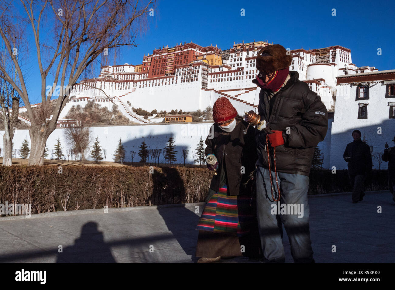 Lhasa, Tibet Autonomous Region, China : Tibetan people perform the kora Buddhist pilgrimage around the Potala Palace. First built in 1645 by the 5th D Stock Photo