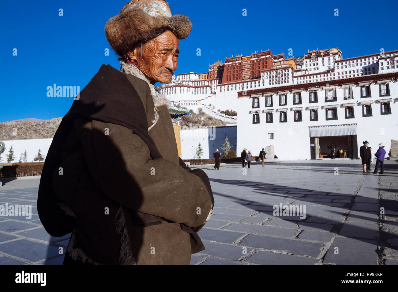 LhasaLhasa, Tibet Autonomous Region, China : A senior Tibetan man stands outside the entrance to the Potala Palace. First built in 1645 by the 5th Dal Stock Photo