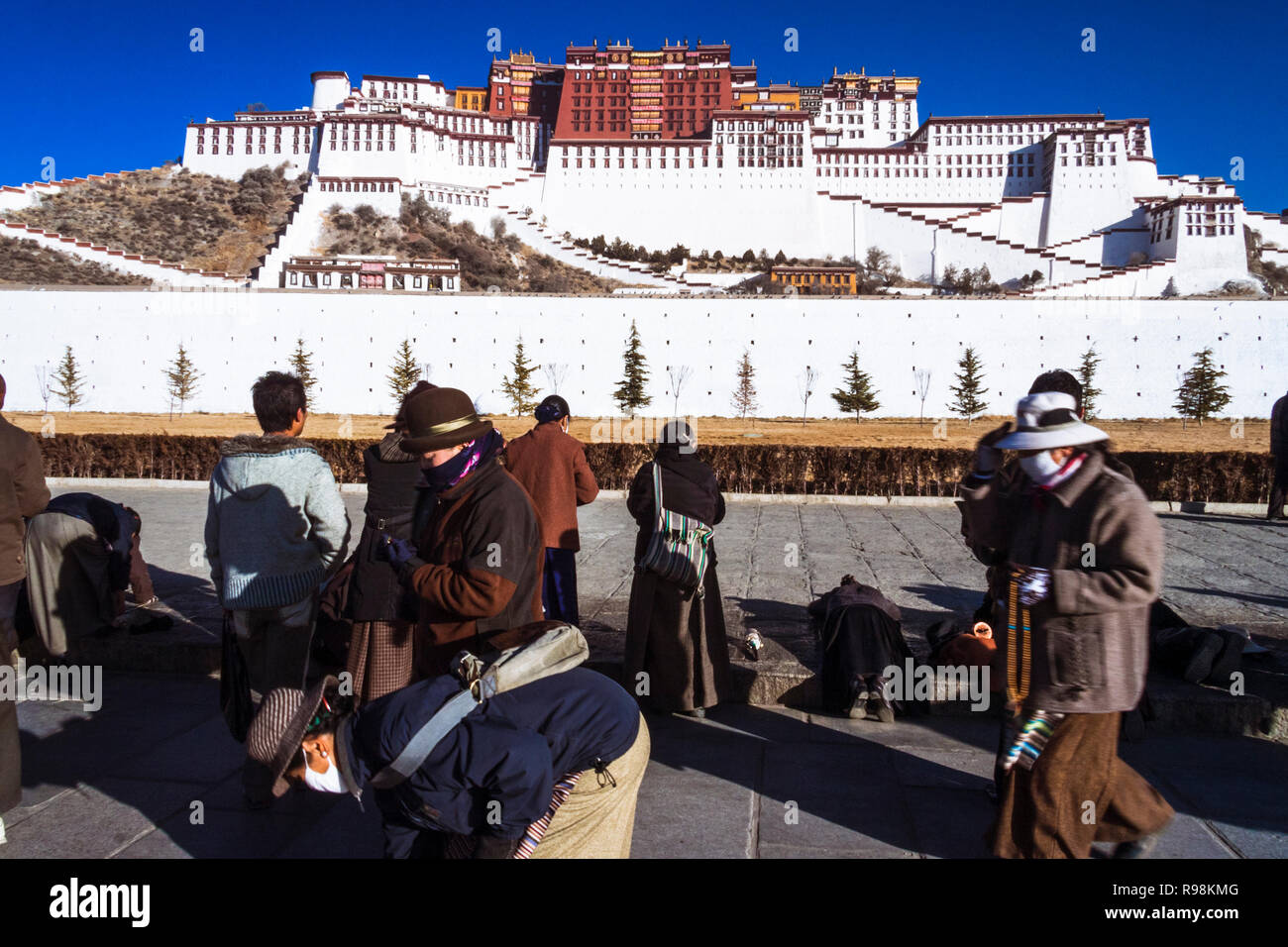 Lhasa, Tibet Autonomous Region, China : Tibetan people perform the kora Buddhist pilgrimage around the Potala Palace. First built in 1645 by the 5th D Stock Photo