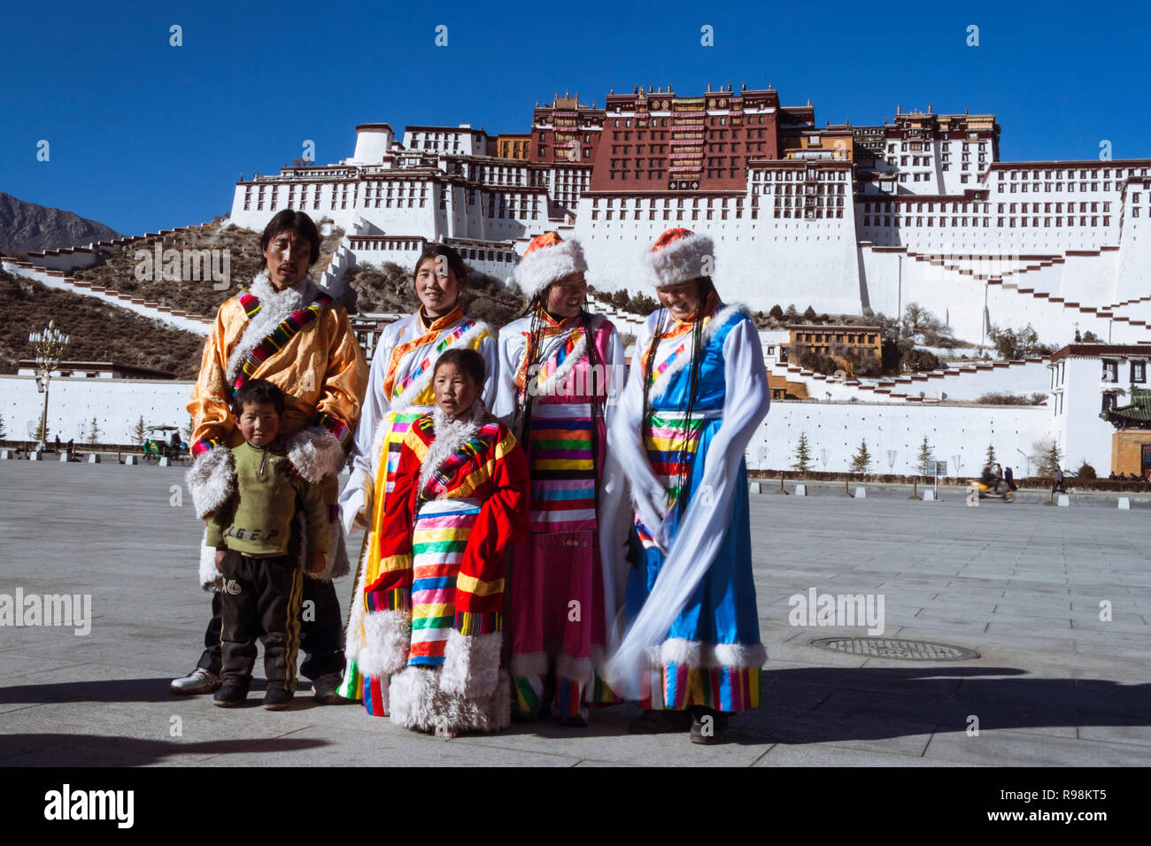 Lhasa, Tibet Autonomous Region, China : Young Tibetan women try out traditional costumes next to Potala palace. First built in 1645 by the 5th Dalai L Stock Photo