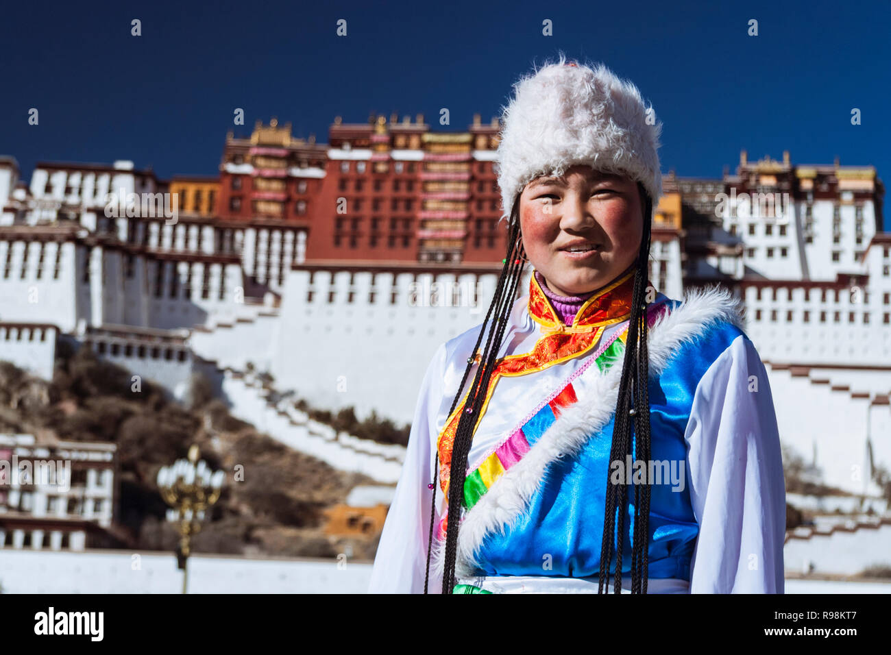 Lhasa, Tibet Autonomous Region, China : Young Tibetan women try out traditional costumes next to Potala palace. First built in 1645 by the 5th Dalai L Stock Photo