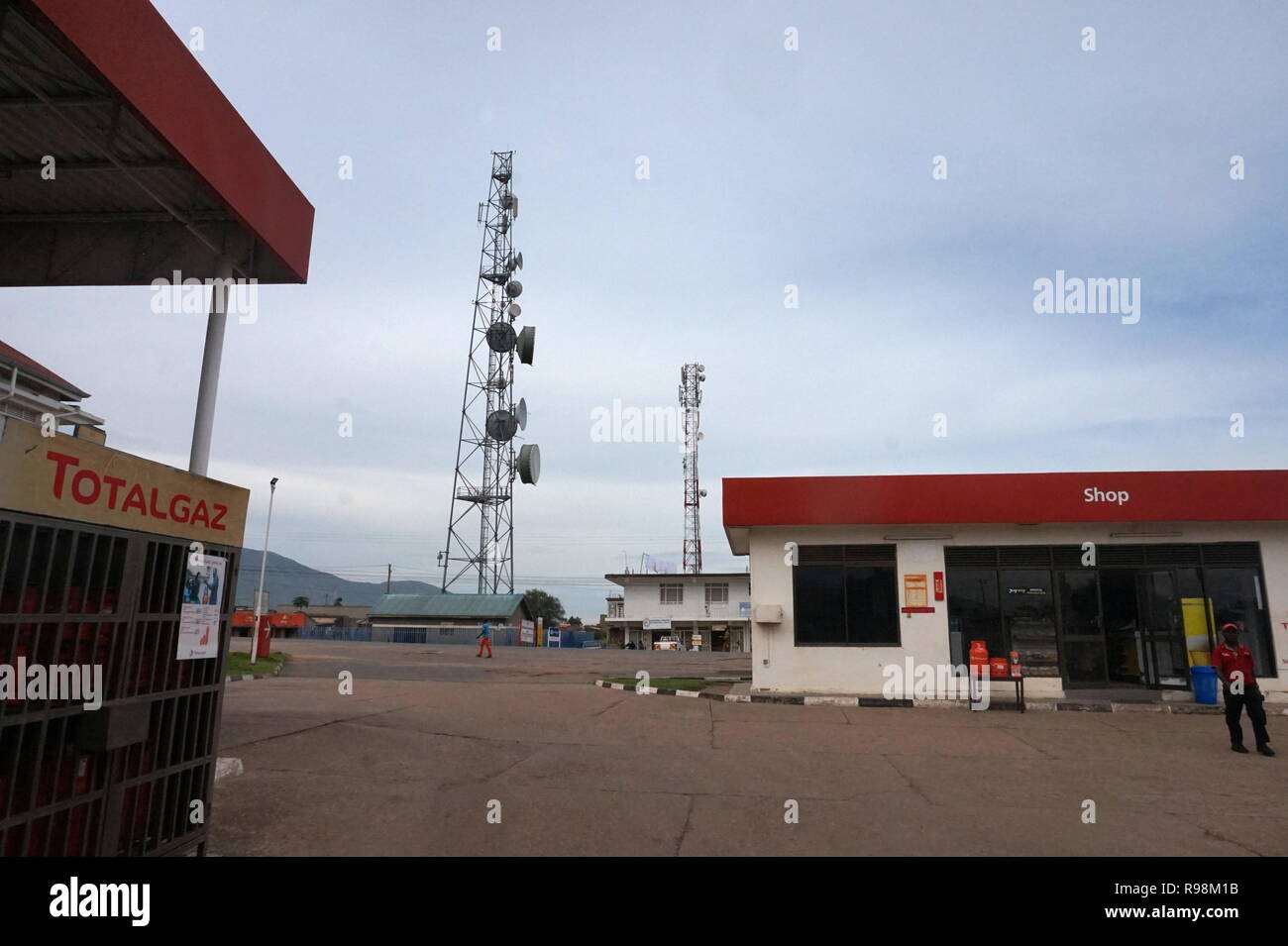 A telecoms aerial in a rural town and a petrol station in Uganda Stock Photo