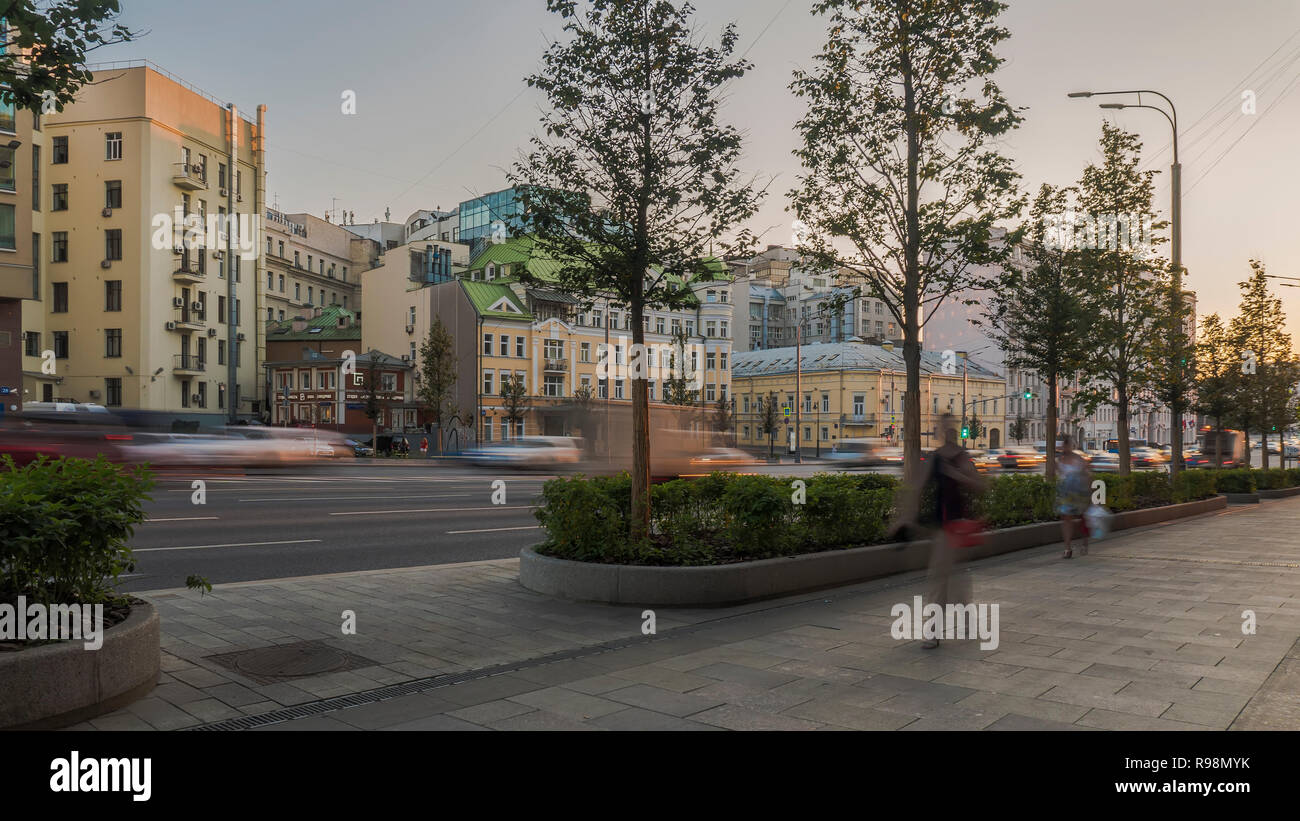 the flow of pedestrians and cars following the city street Stock Photo ...