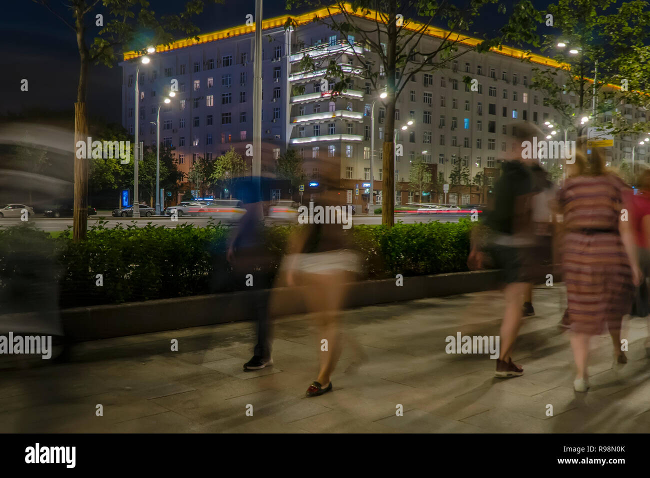 the flow of pedestrians and cars following the city street Stock Photo ...
