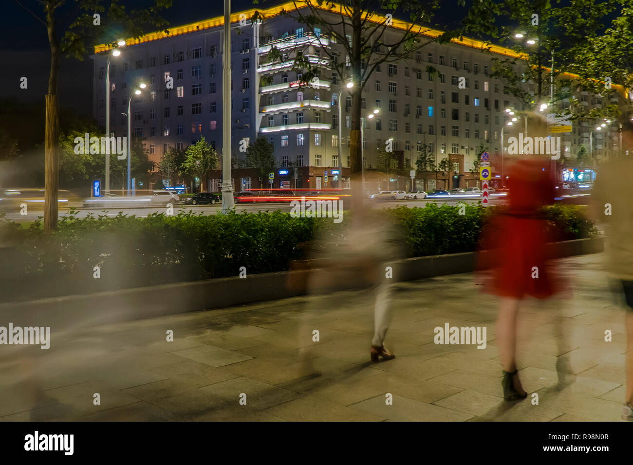 the flow of pedestrians and cars following the city street Stock Photo ...