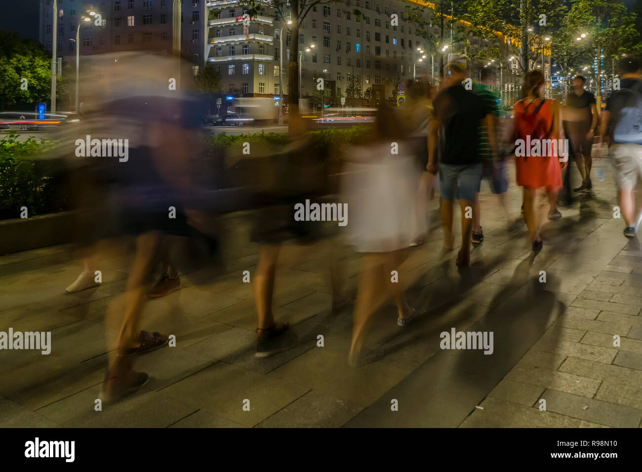 the flow of pedestrians and cars following the city street Stock Photo ...