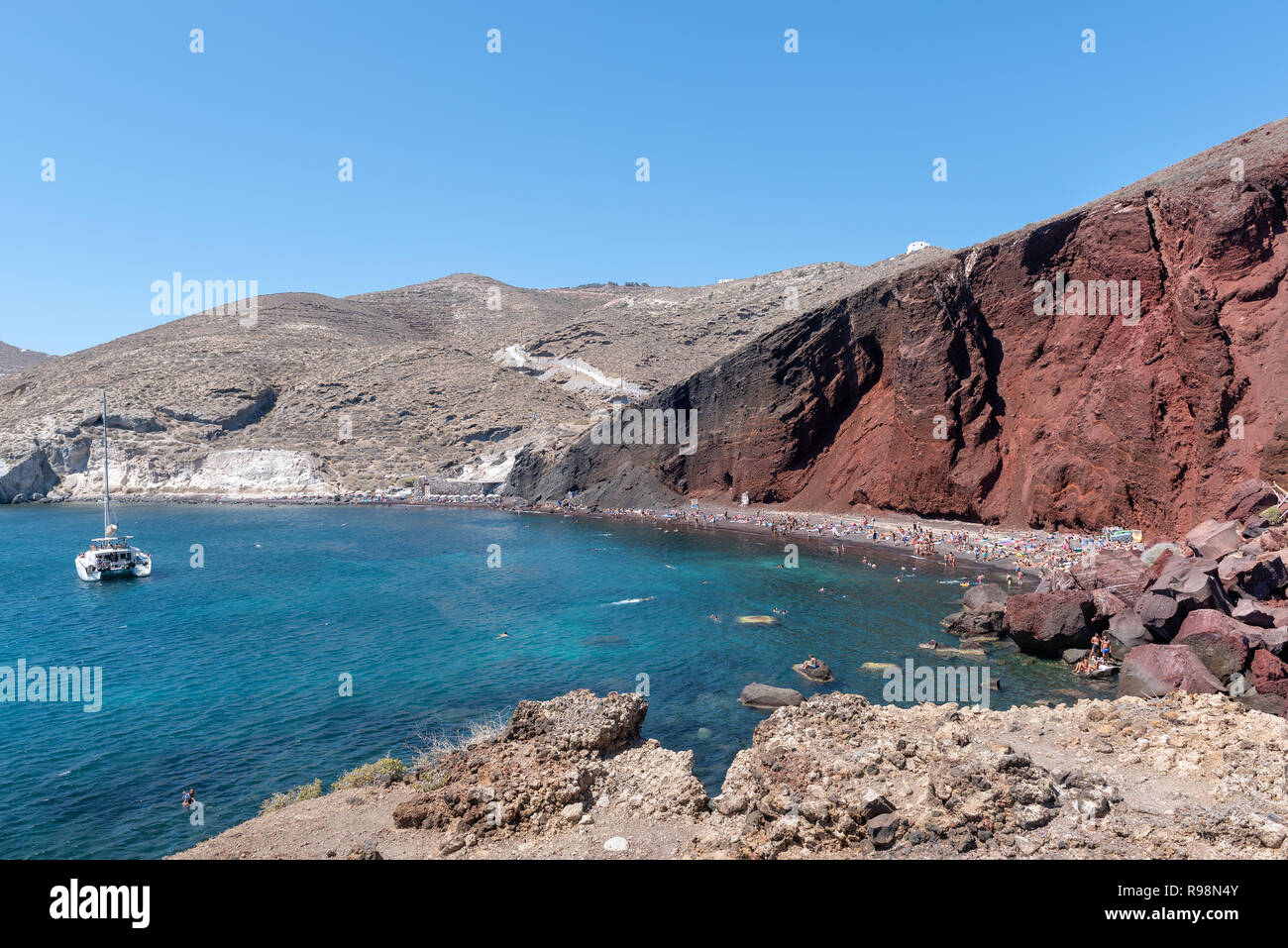 Blue lagoon and red rocks of Santorini island, Greece Stock Photo