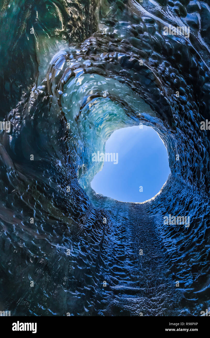 The melted vertical shaft of a moulin, aka glacier mill, the dramatic