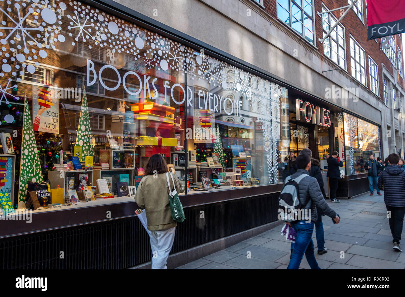 Woman looking at the shop front window display at Foyles