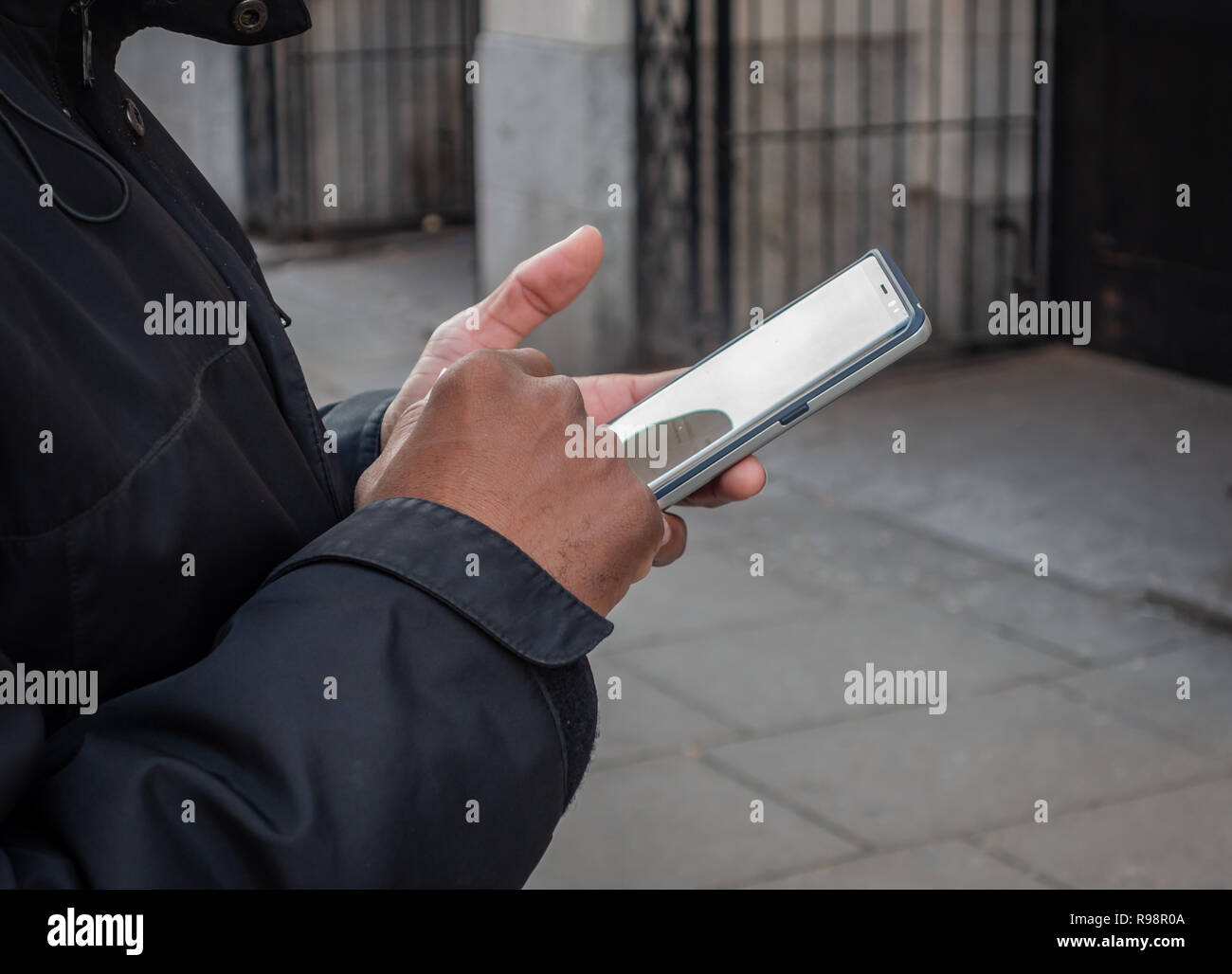 Closeup of mans fingers using a Mobile Phone Stock Photo