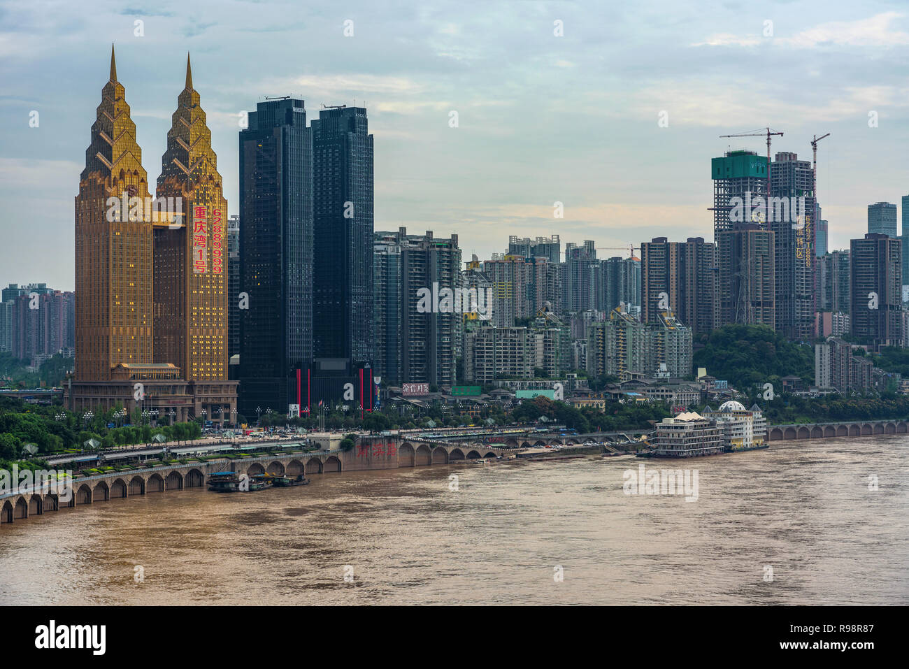 CHONGQING, CHINA - SEPTEMBER 21: Riverside city view of the Sheraton hotel building which is known for its unique gold colour and twin towers design o Stock Photo