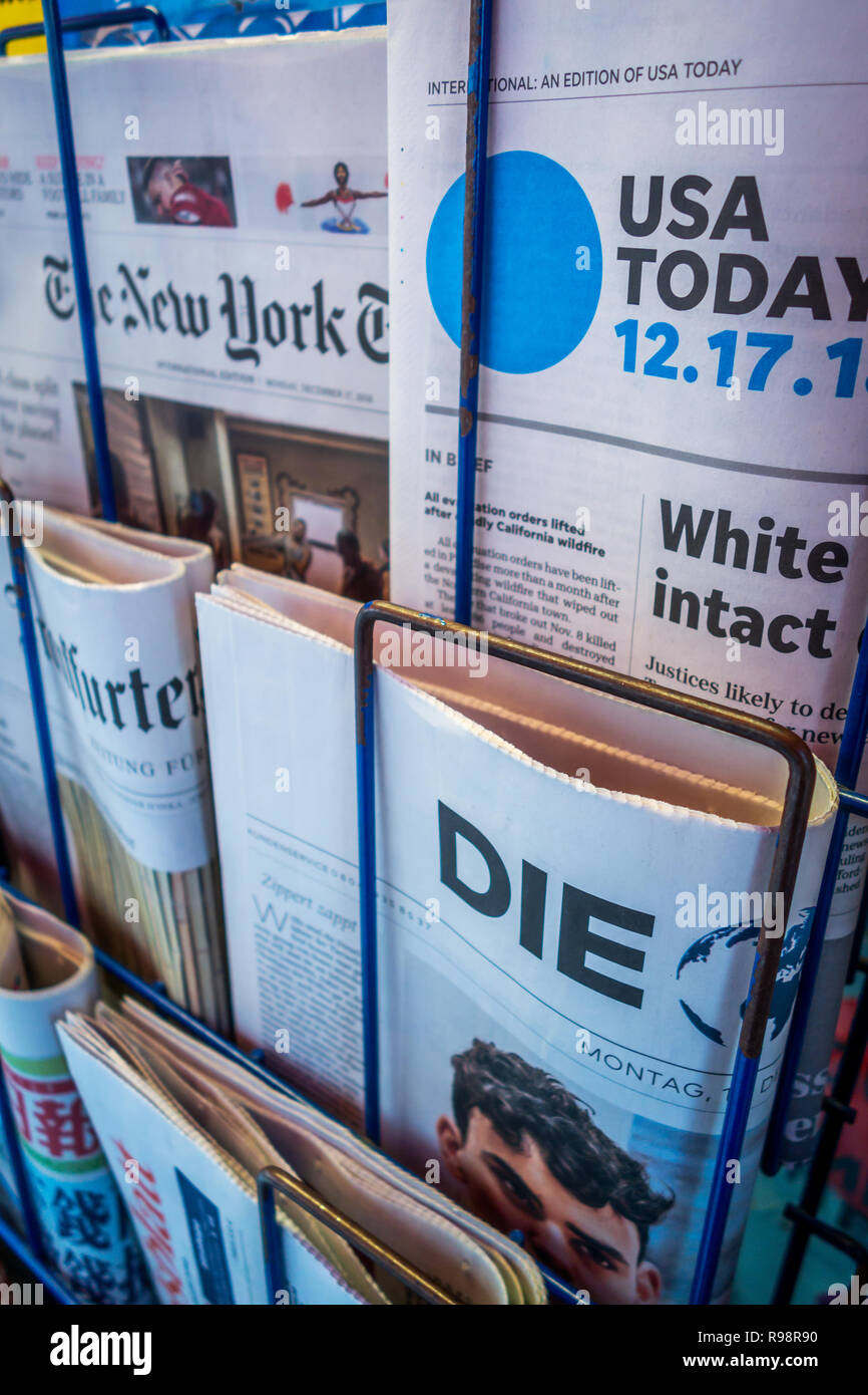 Oblique angle closeup photograph of London Newsstand displaying International Daily Newspapers including The New York Times, USA Today and Die newspap Stock Photo