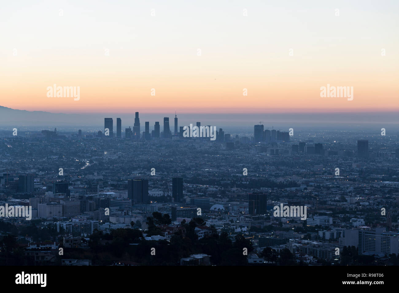 Predawn cityscape view of Hollywood and downtown Los Angeles, California.  Shot from Runyon Canyon Park hiking trail in the Santa Monica Mountains. Stock Photo