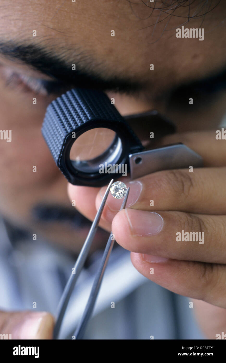 Diamond checking with magnifying eye glass Stock Photo Alamy