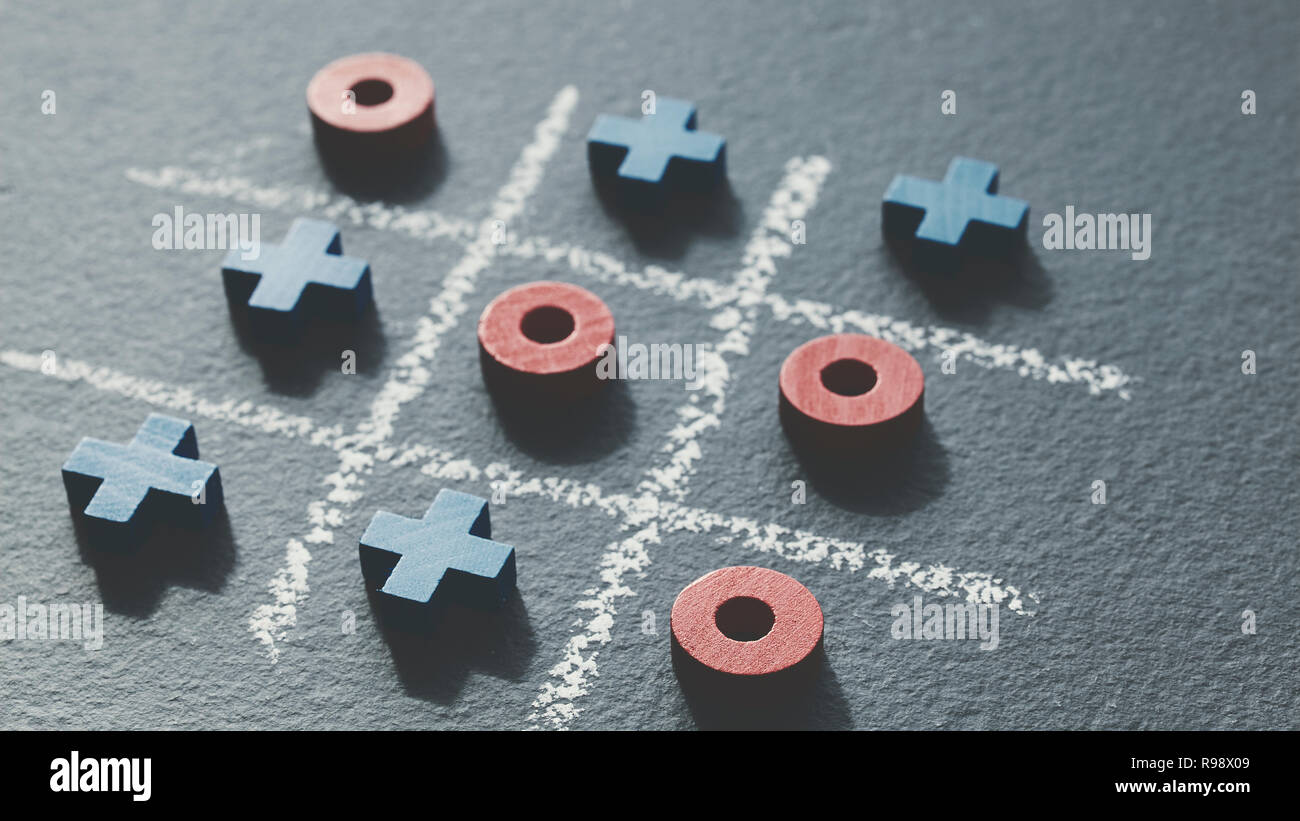 Vintage toned picture of tic tac toe game (noughts and crosses) on dark background, selective focus. Stock Photo