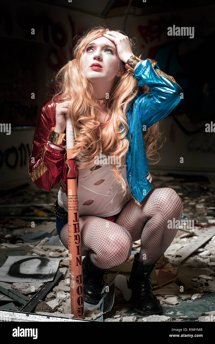 Harley Quinn squats in an abandoned building Stock Photo