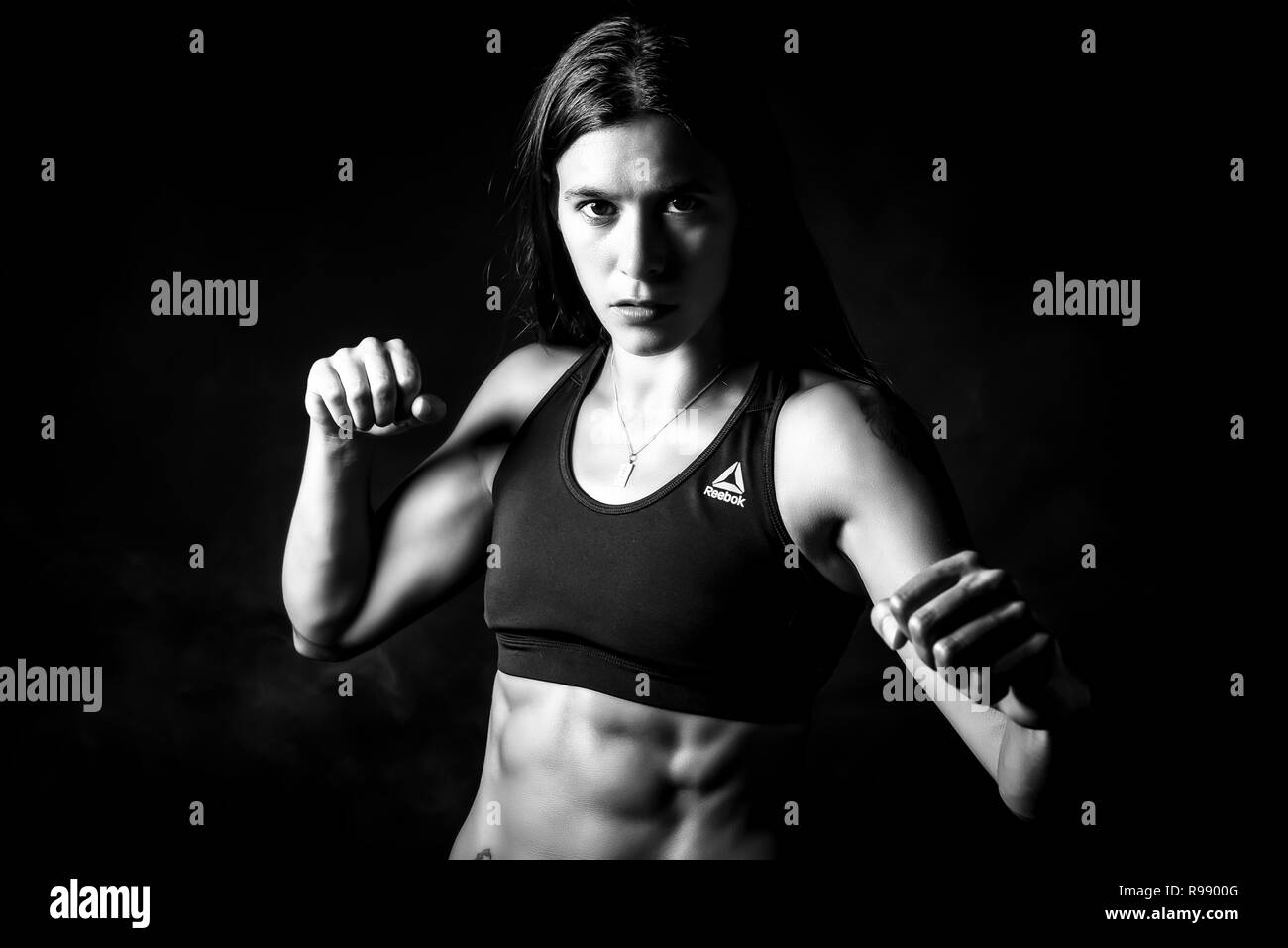 Studio portrait of a young woman with clenched fists Stock Photo