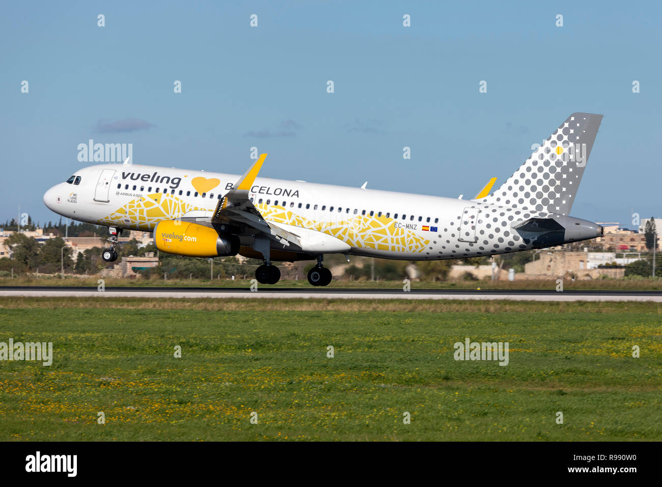 Vueling Airlines Airbus A320-232 (Reg: EC-MNZ) with special livery landing runway 31. Stock Photo