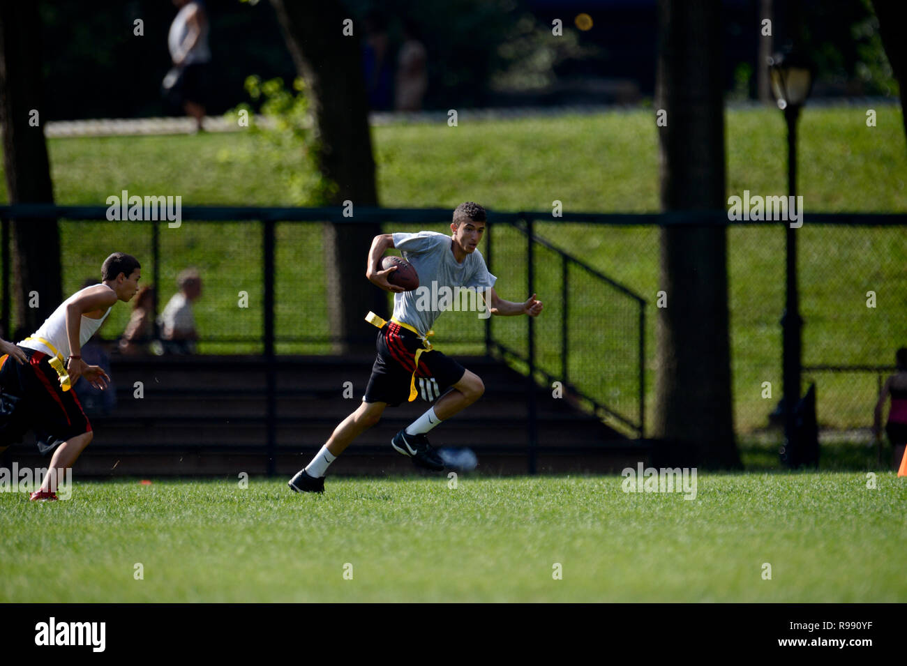 Boys playing touch football in Central Park in New York City Stock Photo
