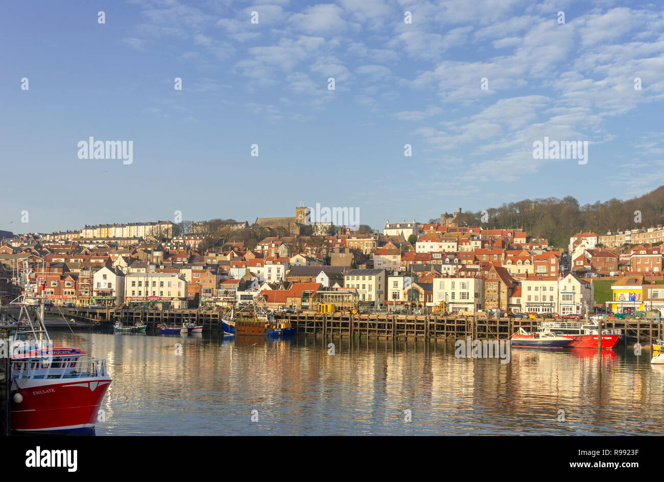 The harbour and town at Scarborough.  Boats are moored in the harbour and the buildings of the town behind. Stock Photo