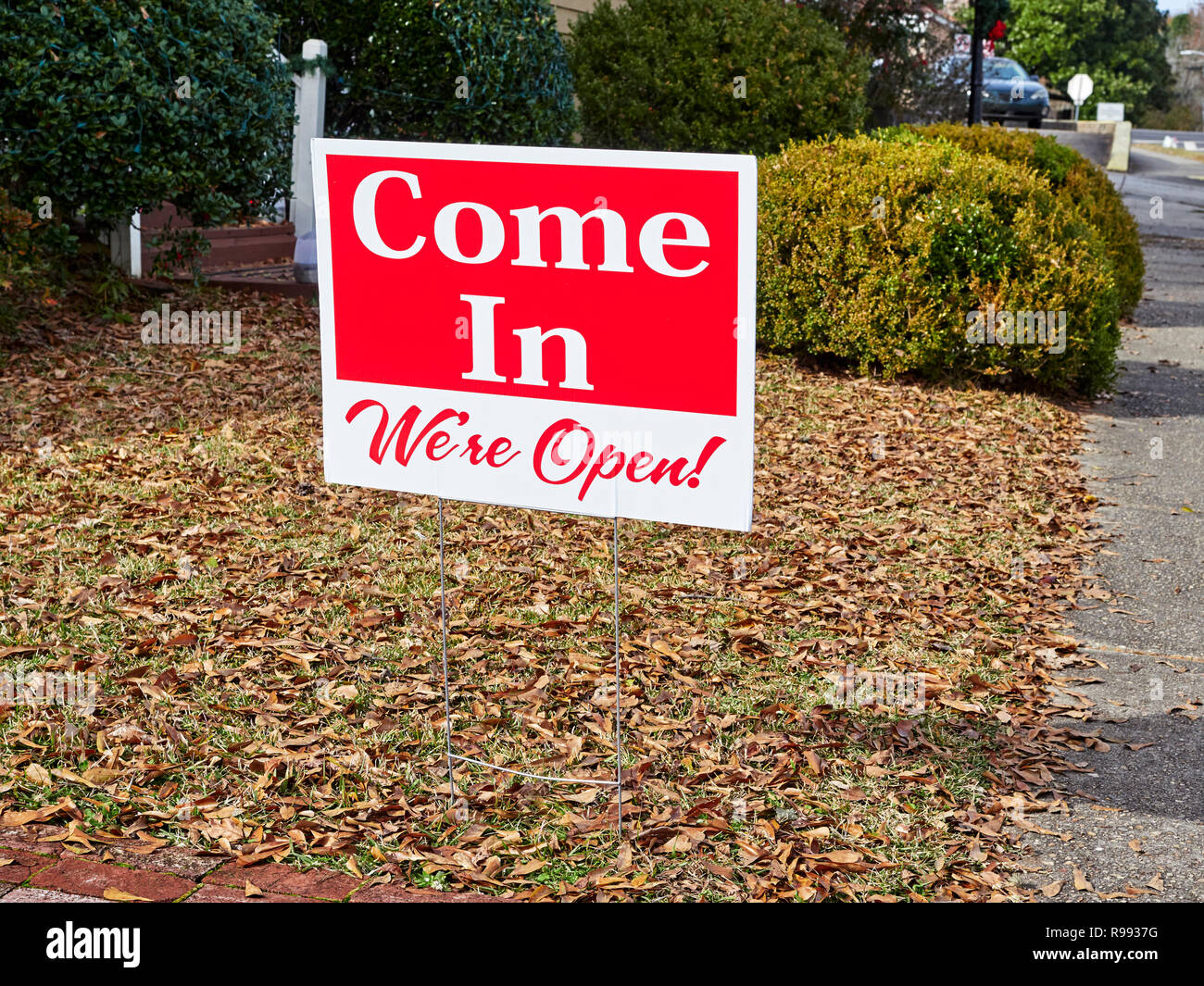 Small yard or snipe sign for a business stating Come In, We're Open, found in Warm Springs Georgia, USA. Stock Photo