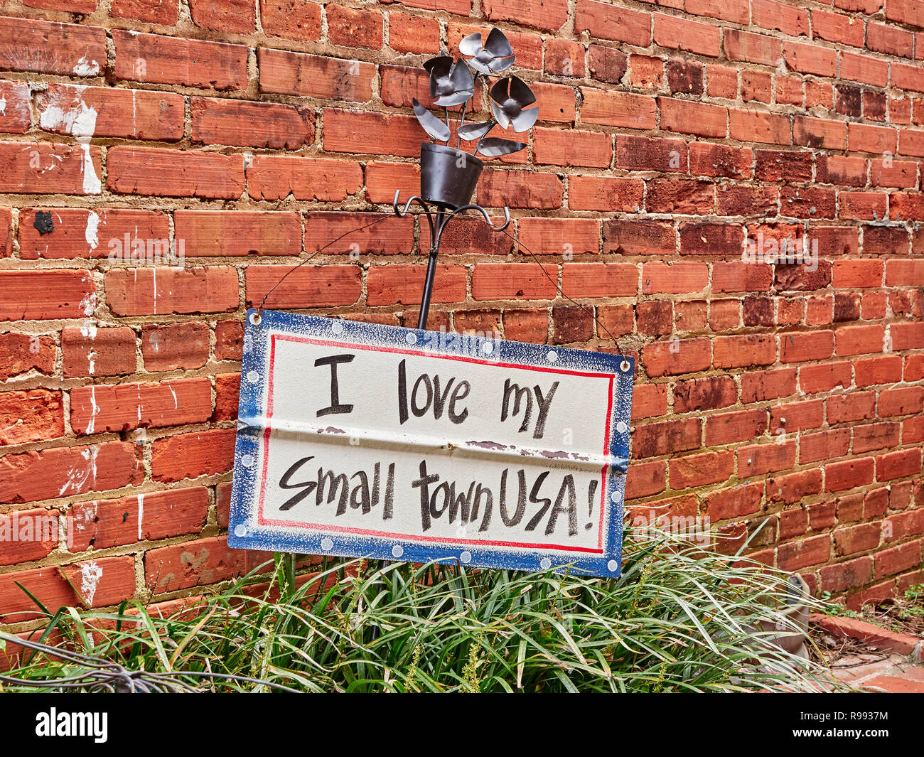 I Love My Small Town sign displayed against a brick wall in Warm Springs Georgia, USA. Stock Photo