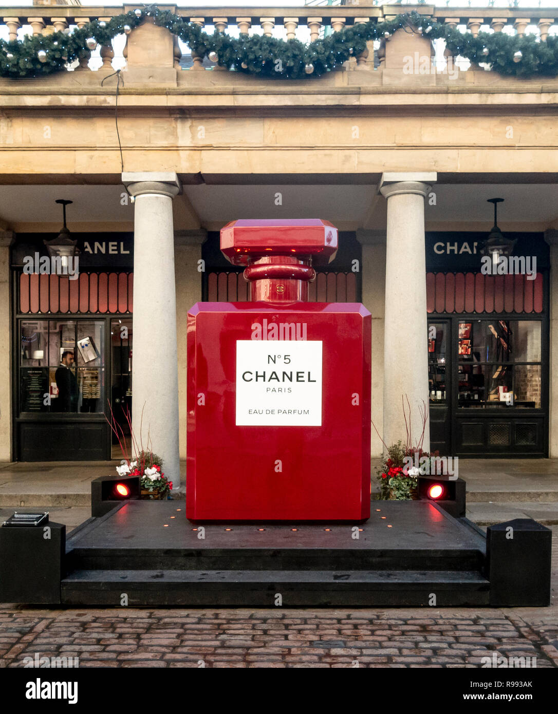 A giant replica of a red, Christmas-styled Chanel No 5 perfume