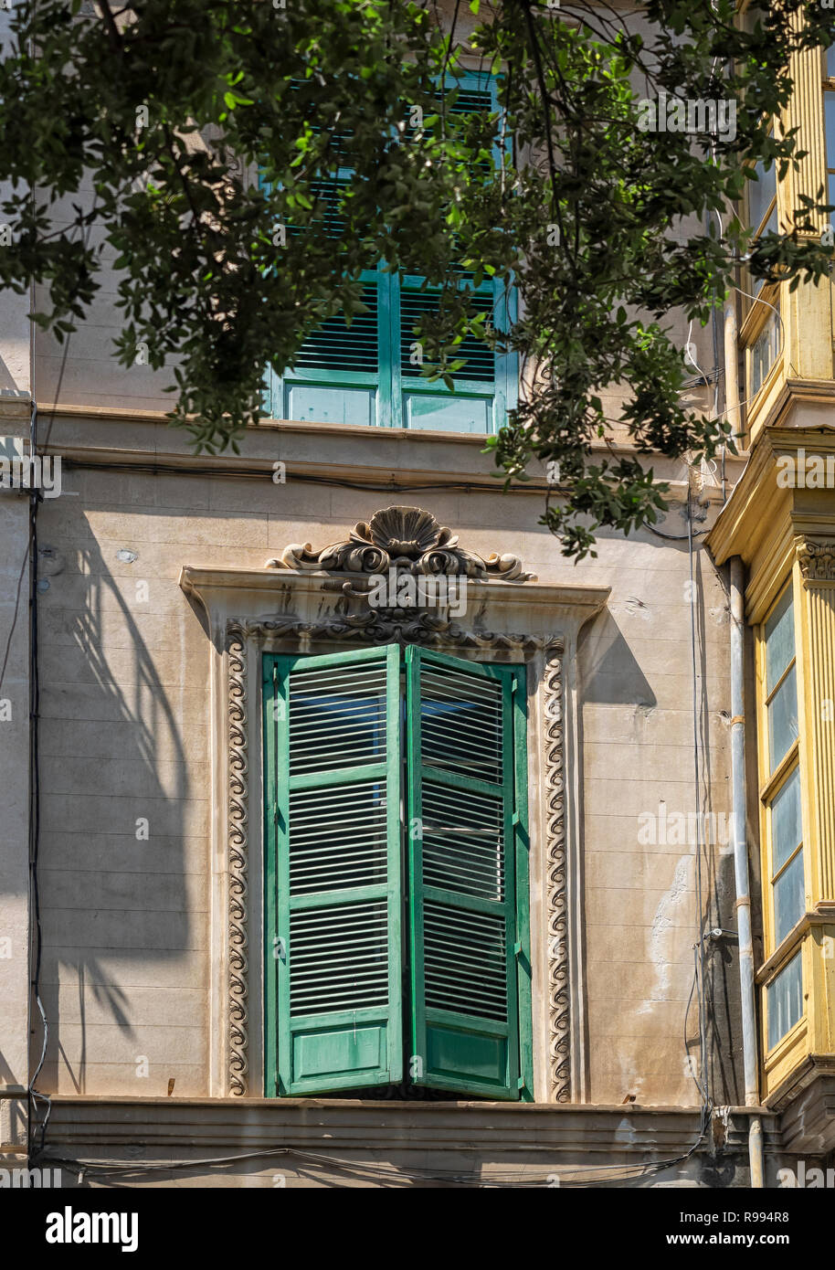 PALMA DE MAJORCA, SPAIN - MAY 23, 2018:  Green Shutters on a window in the old town Stock Photo