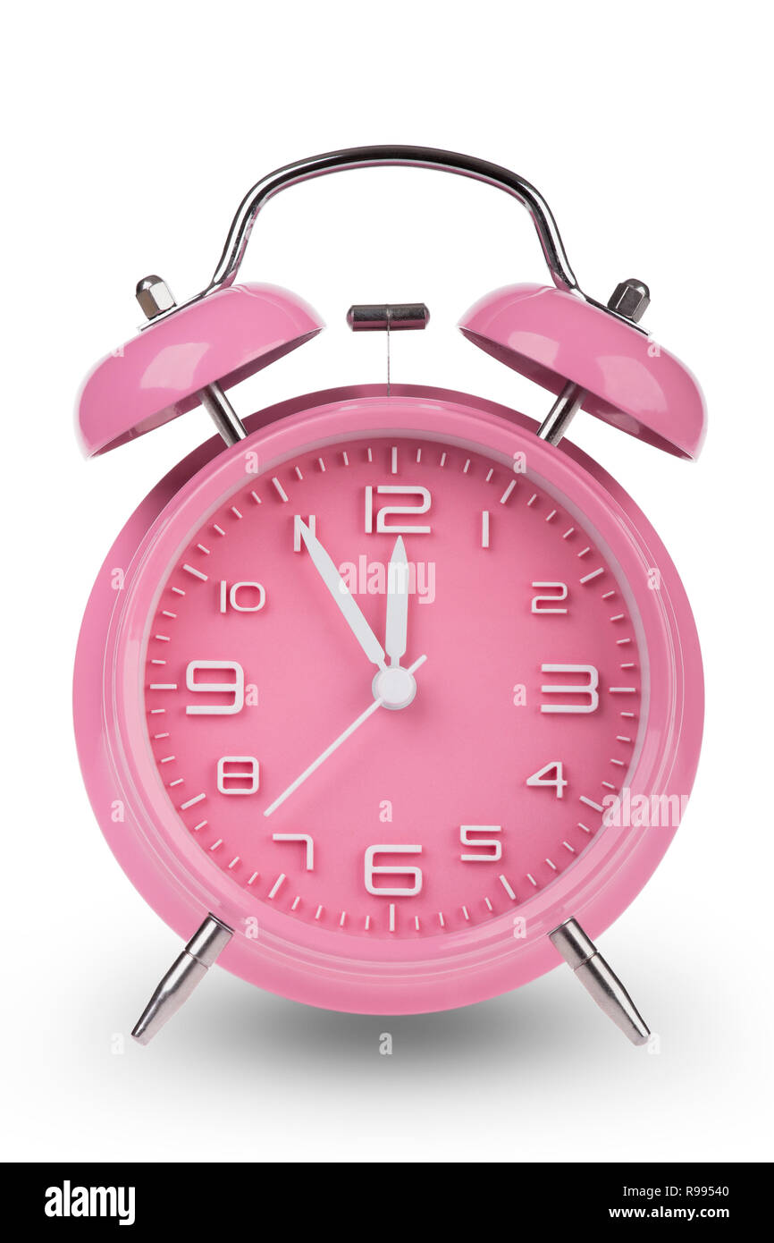 Pink alarm clock with the hands at 5 minutes till 12. Illustrating Time is Running Out isolated on a white background Stock Photo
