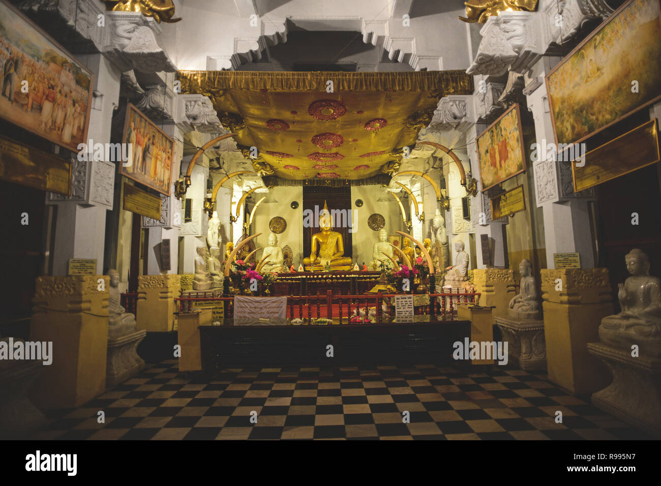 Golden Buddha statue inside the Temple of the Sacred Tooth Relic, Kandy, Sri Lanka, Stock Photo