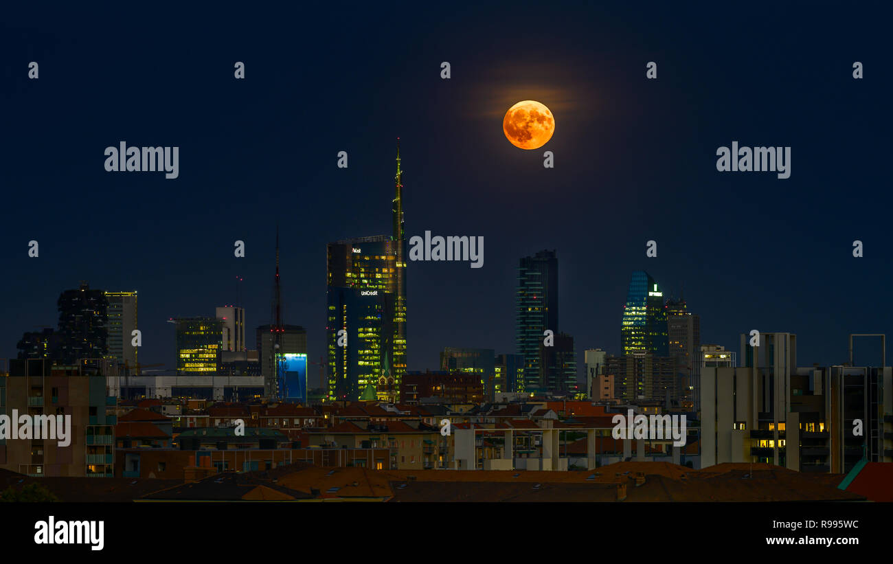 The full moon is rising in milan by night stock photo alamy