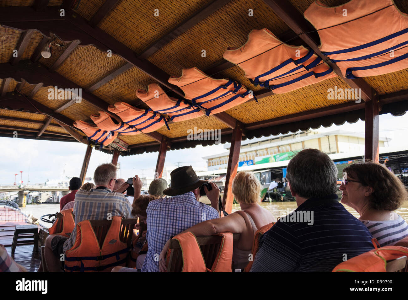 Lifejackets above tourists on a river boat trip day cruise sailing in Mekong Delta. Cai Be, Tiền