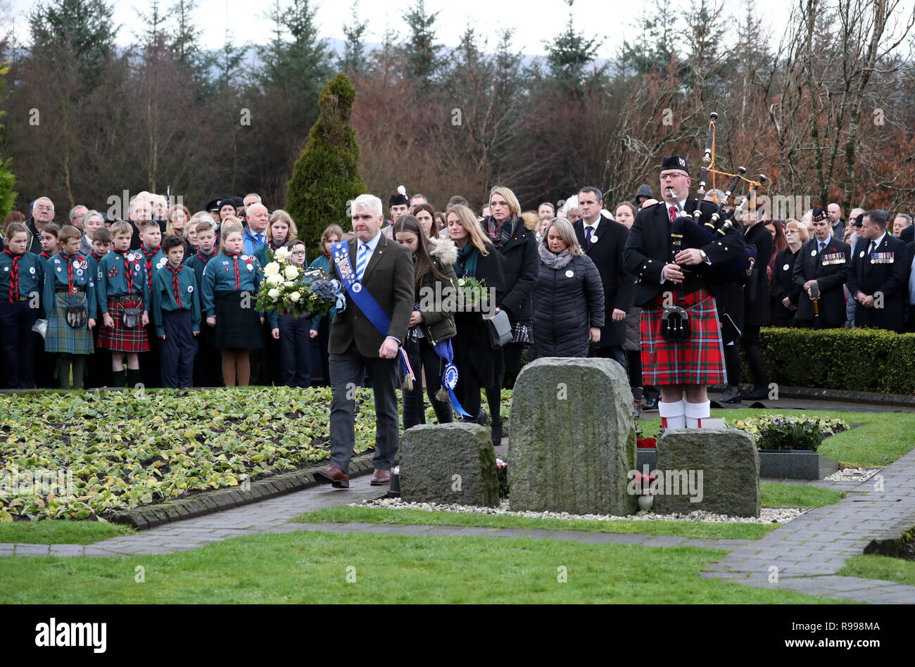 A piper plays as people gather to pay their respects at the commemoration service to mark the 30th anniversary of the Lockerbie bombing at the Memorial Garden, Dryfesdale Cemetery, Lockerbie. Stock Photo