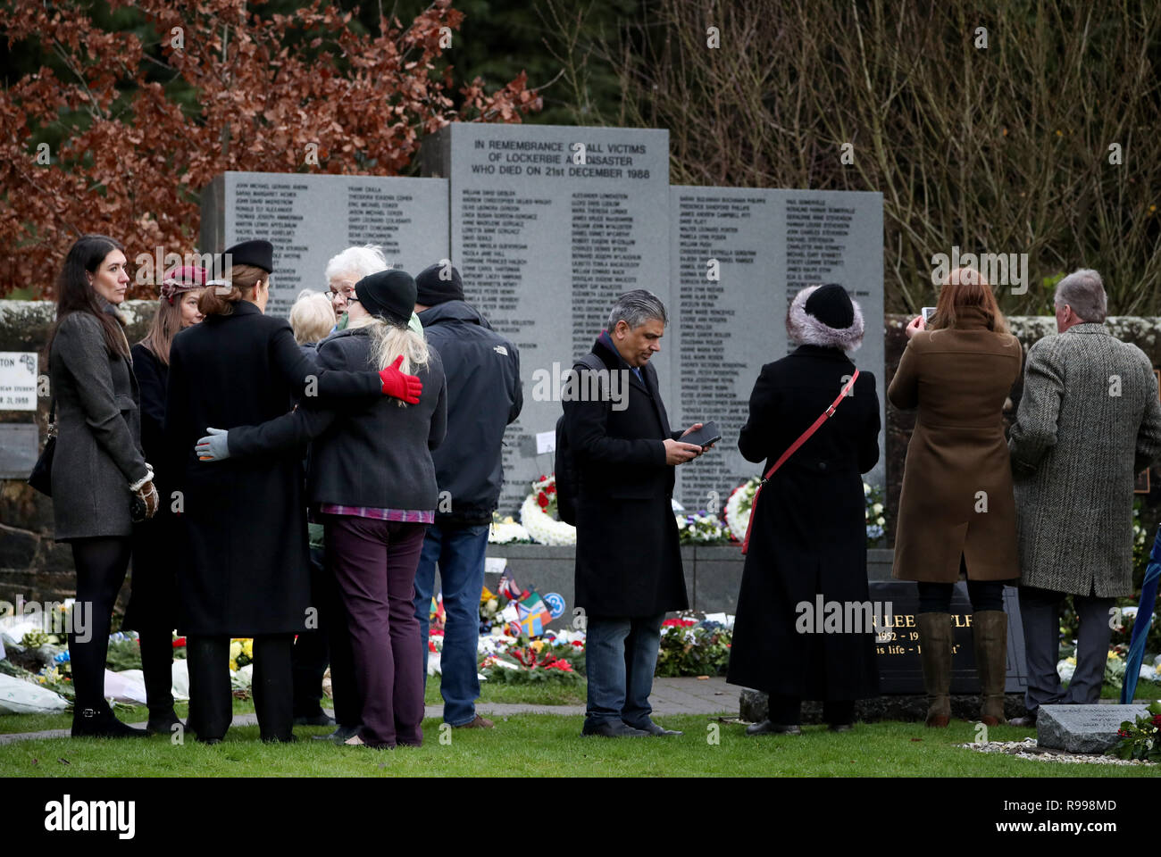 People gather to pay their respects at the commemoration service to mark the 30th anniversary of the Lockerbie bombing at the Memorial Garden, Dryfesdale Cemetery, Lockerbie. Stock Photo
