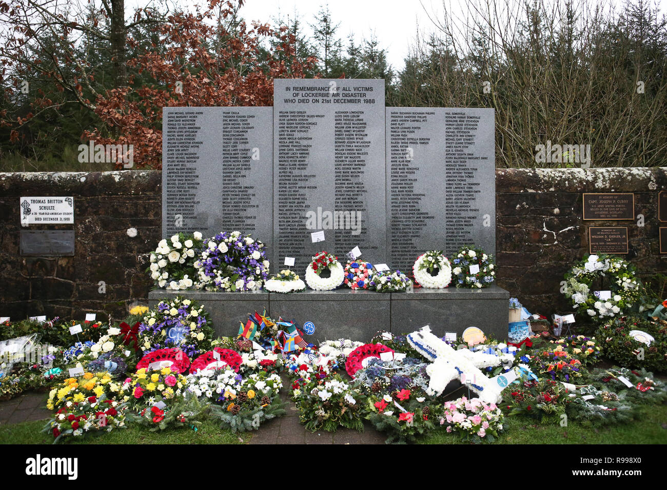 Wreaths and floral tributes left during the commemoration service in the Memorial Garden at Dryfesdale Cemetery in Lockerbie to mark the 30th anniversary of the Lockerbie bombing. Stock Photo