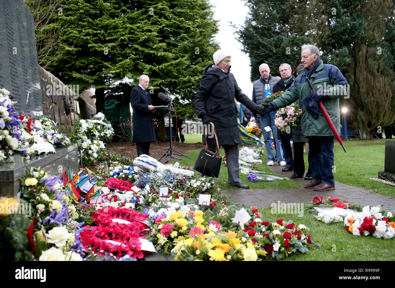 People pay their respects during the commemoration service in the Memorial Garden at Dryfesdale Cemetery in Lockerbie to mark the 30th anniversary of the Lockerbie bombing. Stock Photo