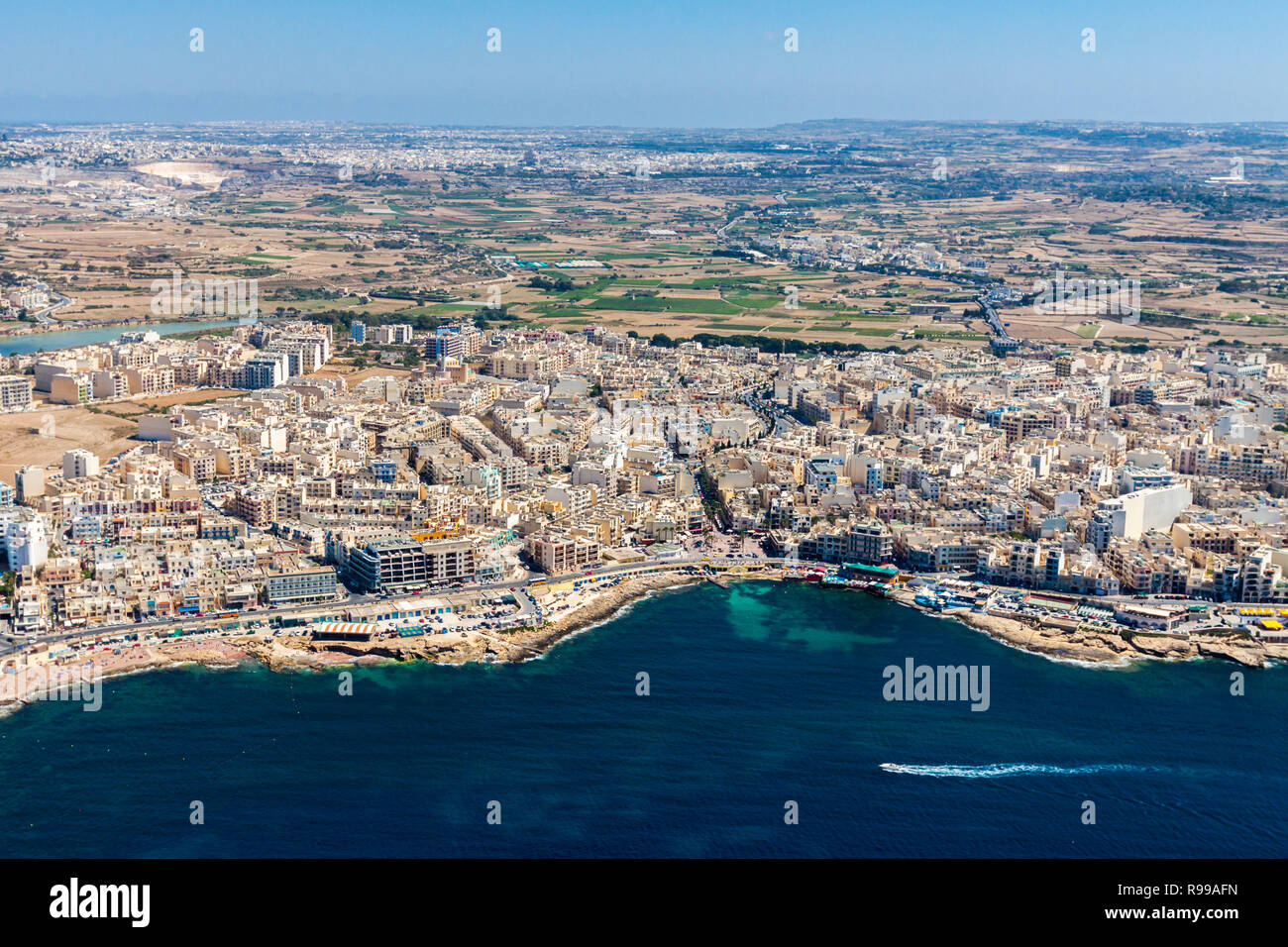 Aerial view of Bugibba town, St. Paul's Bay in the Northern Region, Malta. Popular tourist resort destination with promenade, hotels, restaurants, pubs, clubs, and a casino. Stock Photo