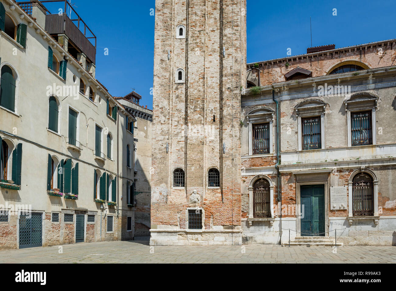Medieval tower and old houses at the square of Venice old town, Italy Stock Photo
