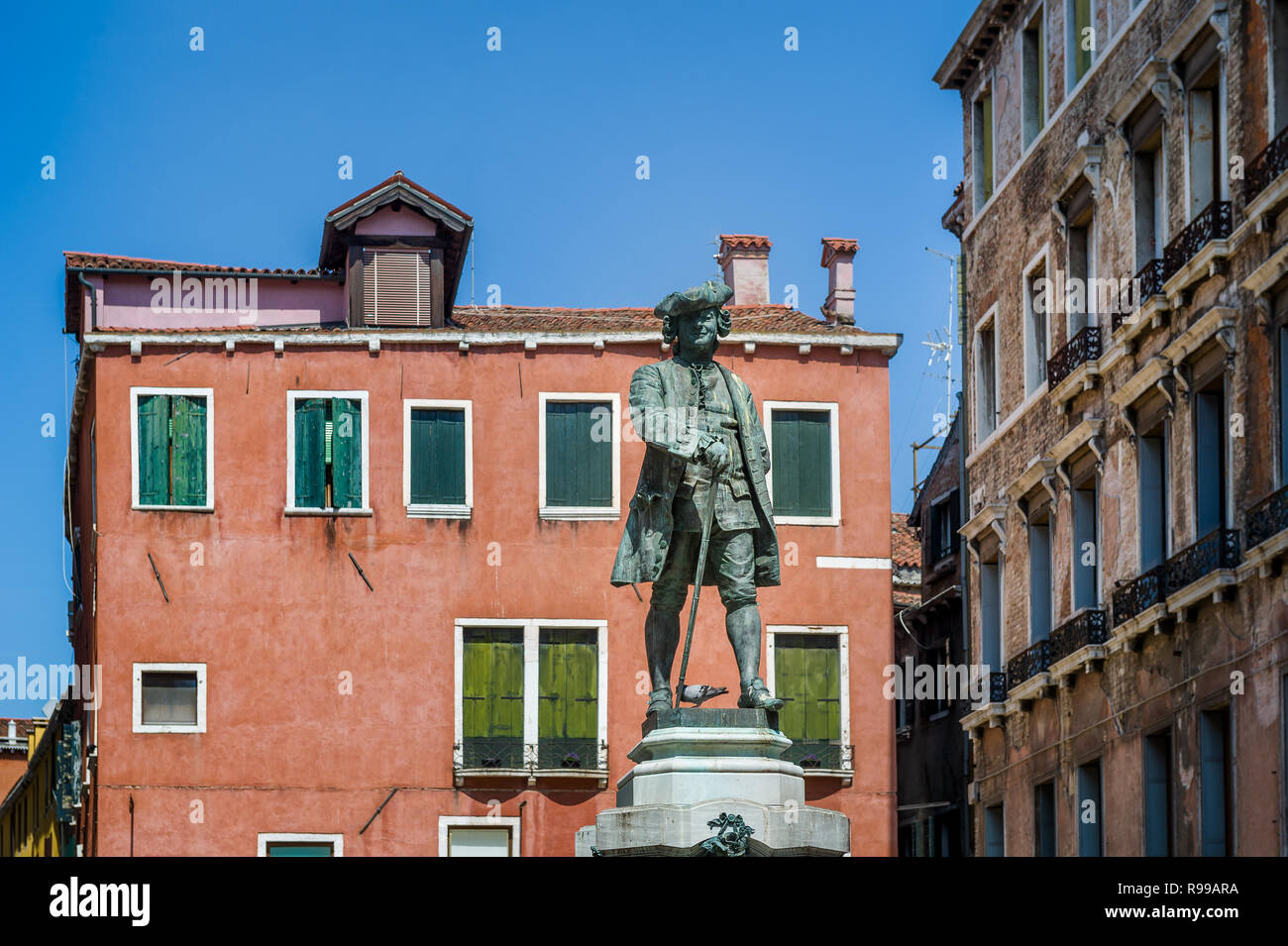 Statue at the square with historical houses in Venice touristic center. Veneto, Italy. Stock Photo